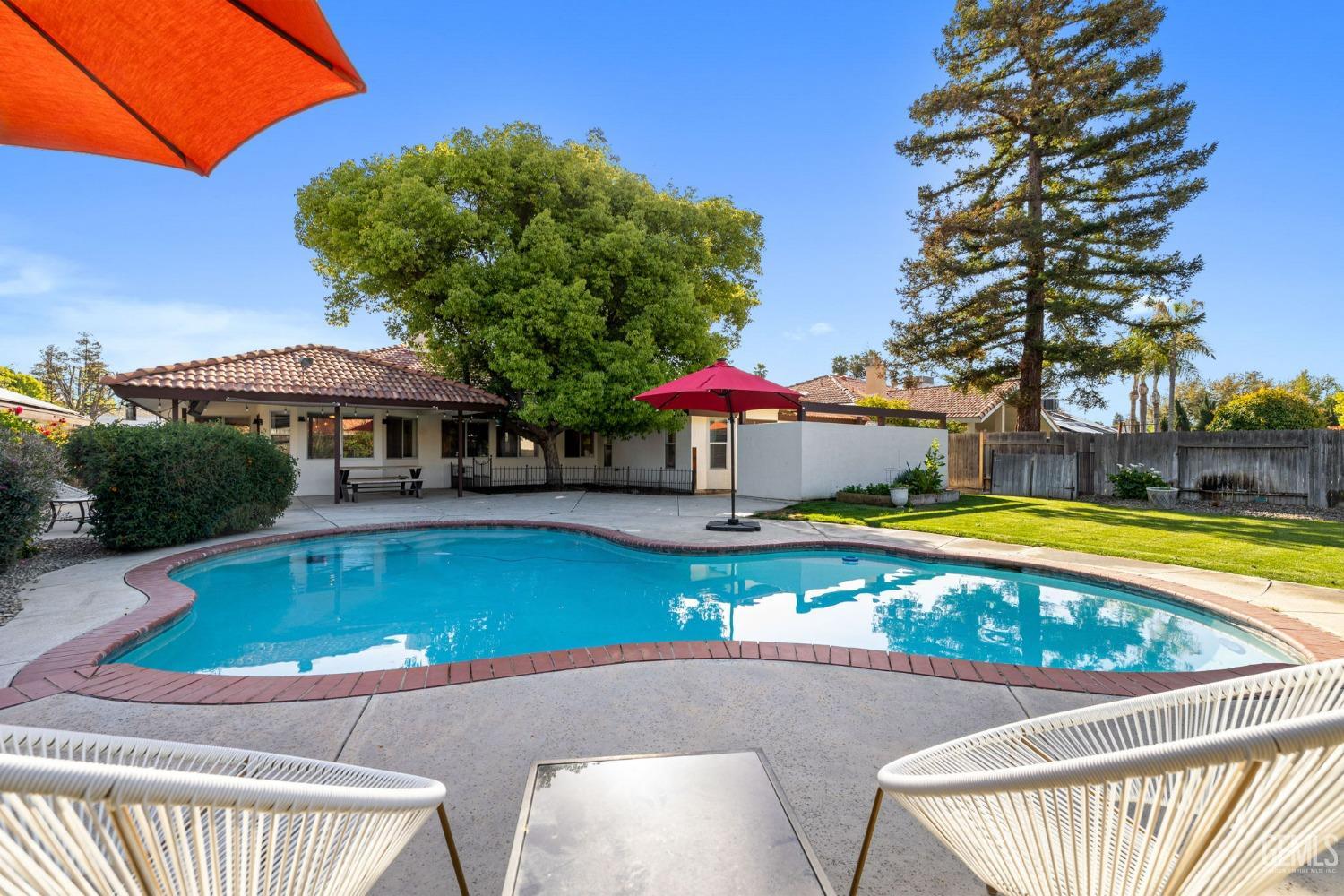 Undisclosed Address Bakersfield, CA 93311 - Photo 54 of 69 a view of swimming pool with seating space and yard