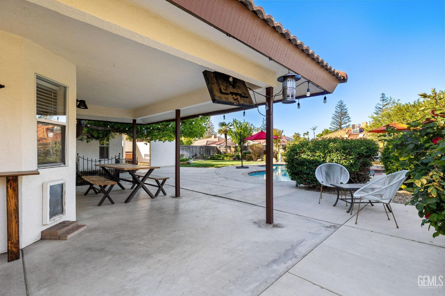 Undisclosed Address Bakersfield, CA 93311 - Photo 59 of 69 a view of a patio with table and chairs under an umbrella