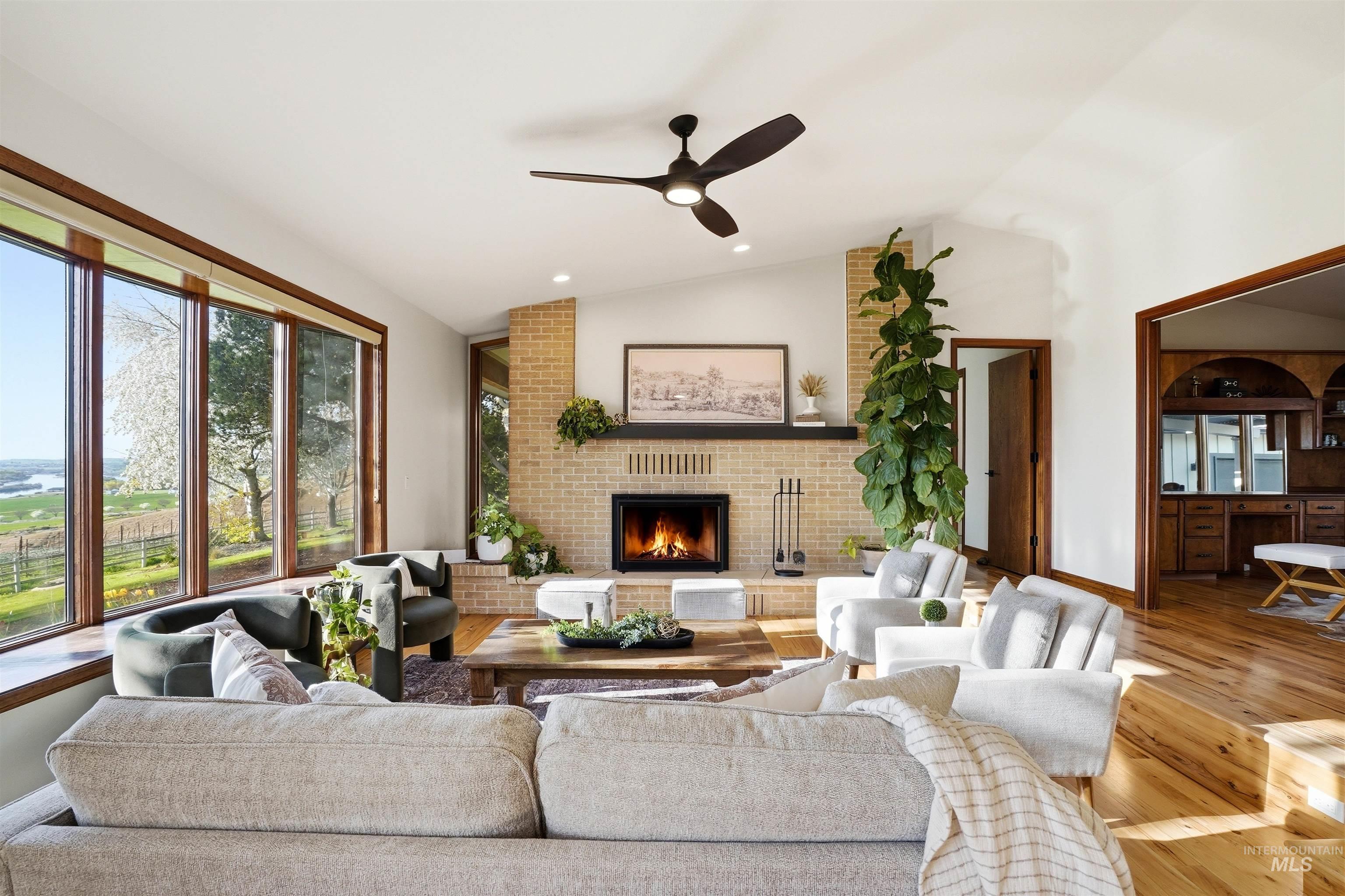 12730 Sunny Slope Road Caldwell, ID 83607 - Photo 15 of 50 Living area with ceiling fan, vaulted ceiling, a brick fireplace, hardwood / wood-style flooring, and recessed lighting