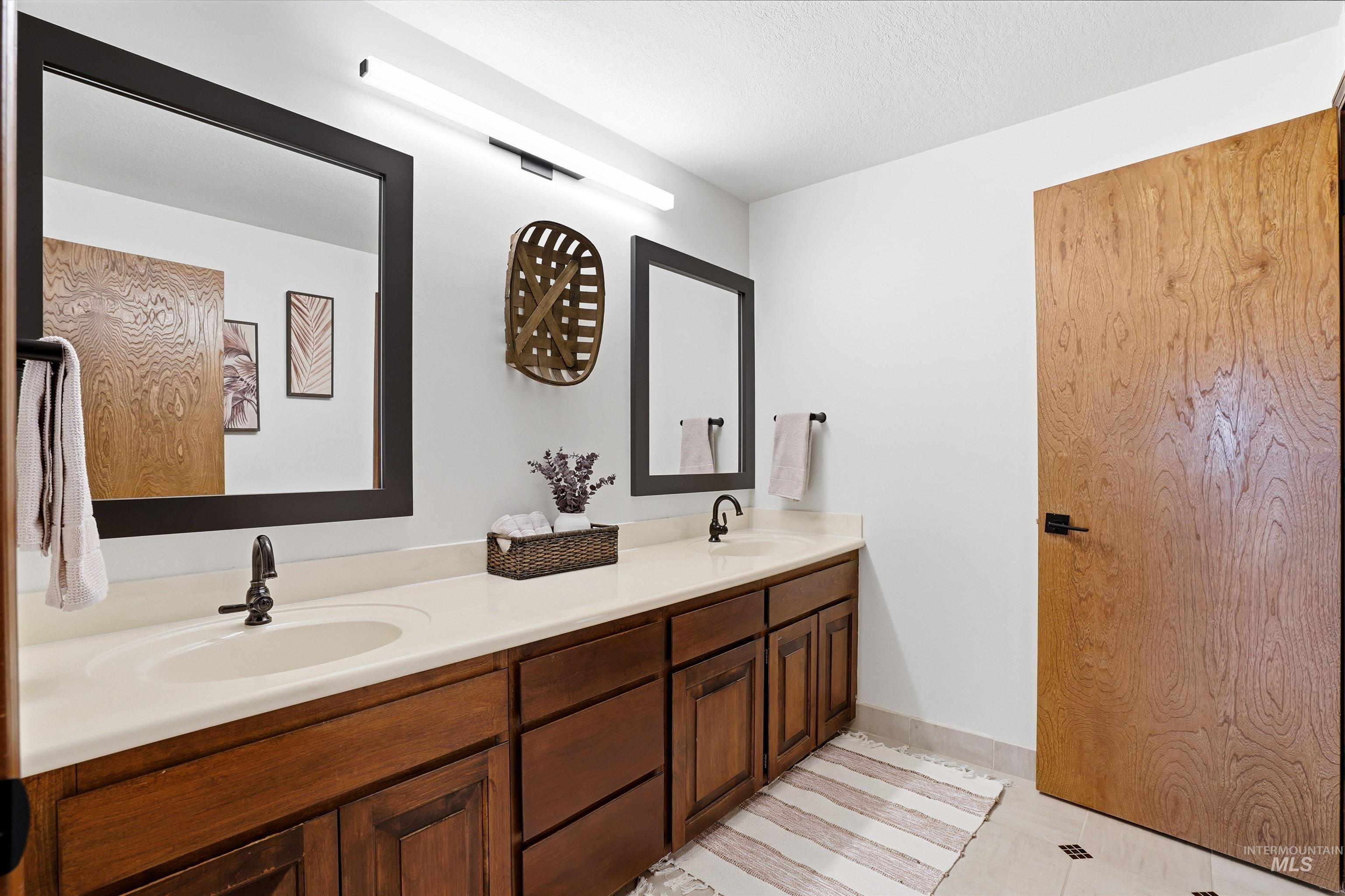 12730 Sunny Slope Road Caldwell, ID 83607 - Photo 37 of 50 Bathroom with double vanity and a textured ceiling