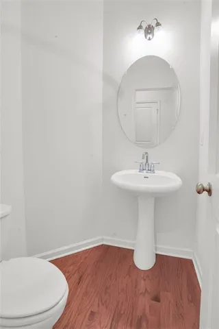 a bathroom with a sink toilet and a mirror