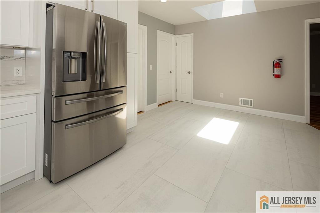 278 Rector Street Perth Amboy, NJ 08861 - Photo 10 of 47 a kitchen with stainless steel appliances a refrigerator and a window