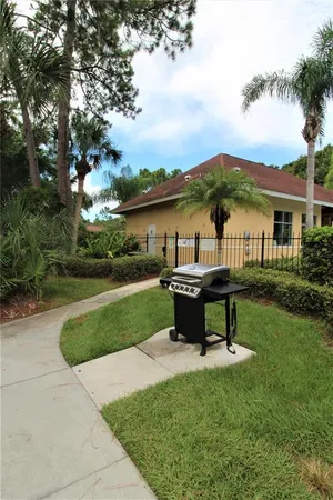a view of a house with garden and a bench