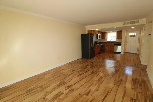 a view of a hallway with wooden floor