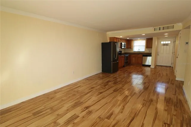 a view of a hallway with wooden floor