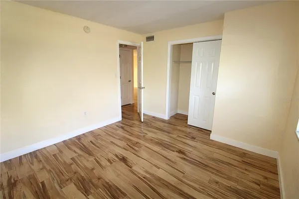 a view of a room with wooden floor and bench
