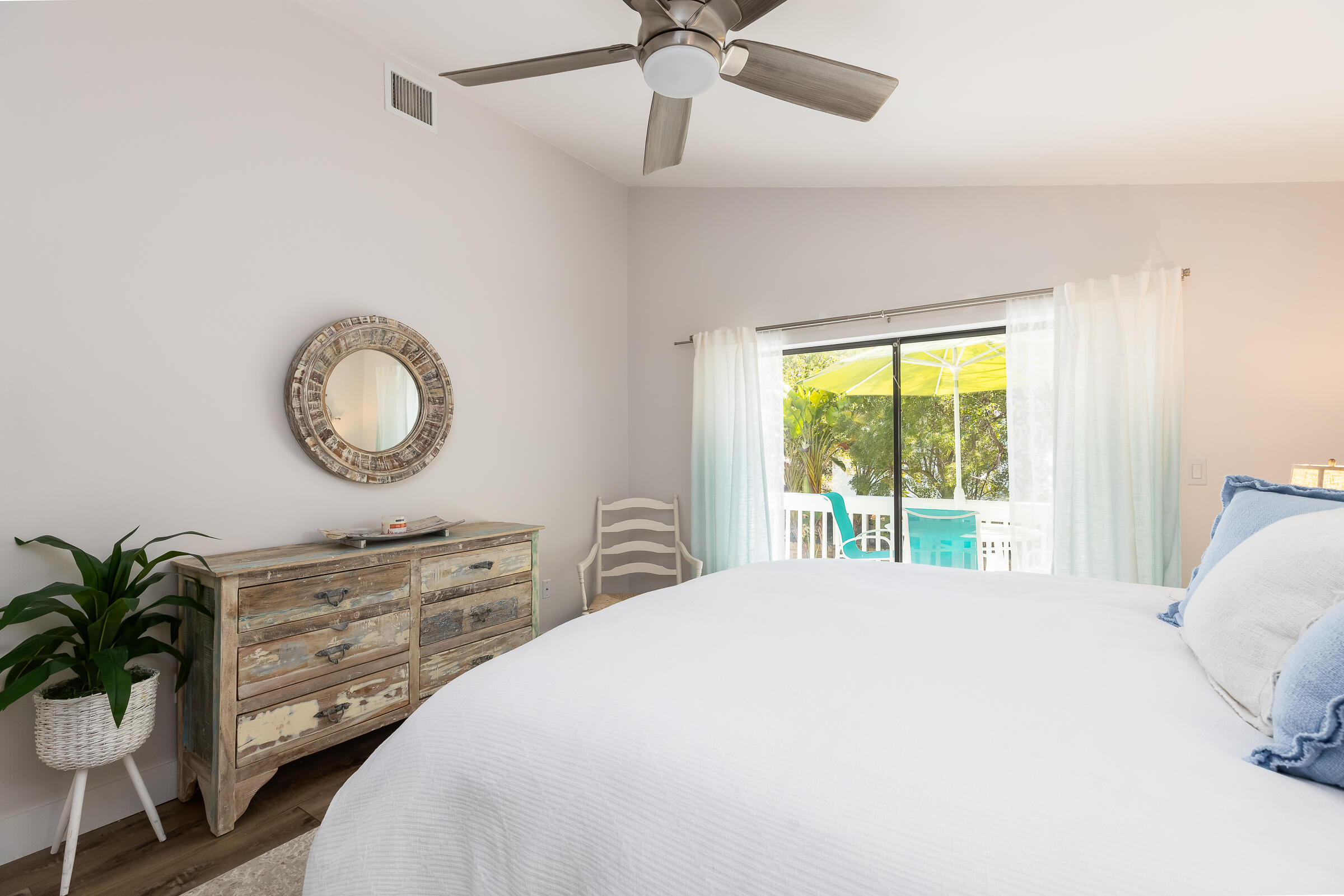 15 Sunset Road Key Largo, FL 33037 - Photo 26 of 58 a bedroom with a bed and a chandelier