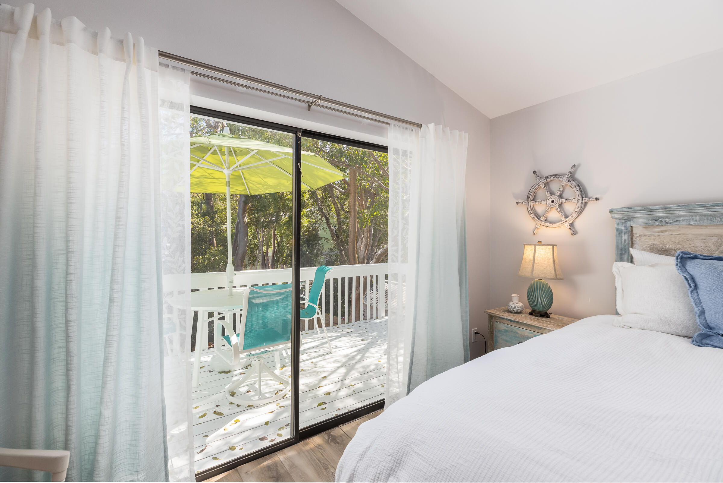 15 Sunset Road Key Largo, FL 33037 - Photo 27 of 58 a bedroom with a large bed and a chandelier