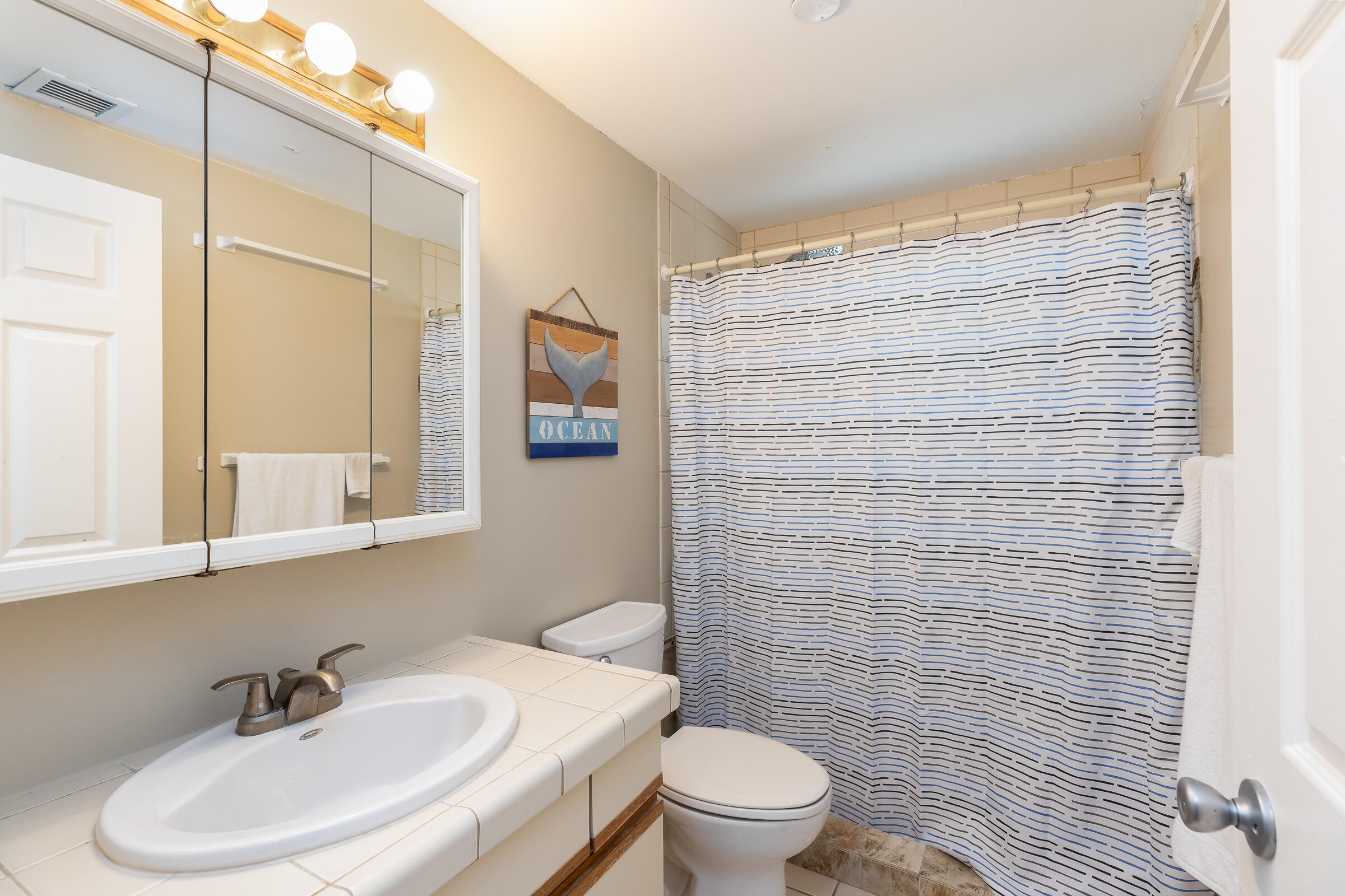 15 Sunset Road Key Largo, FL 33037 - Photo 32 of 58 a bathroom with a sink a toilet and shower