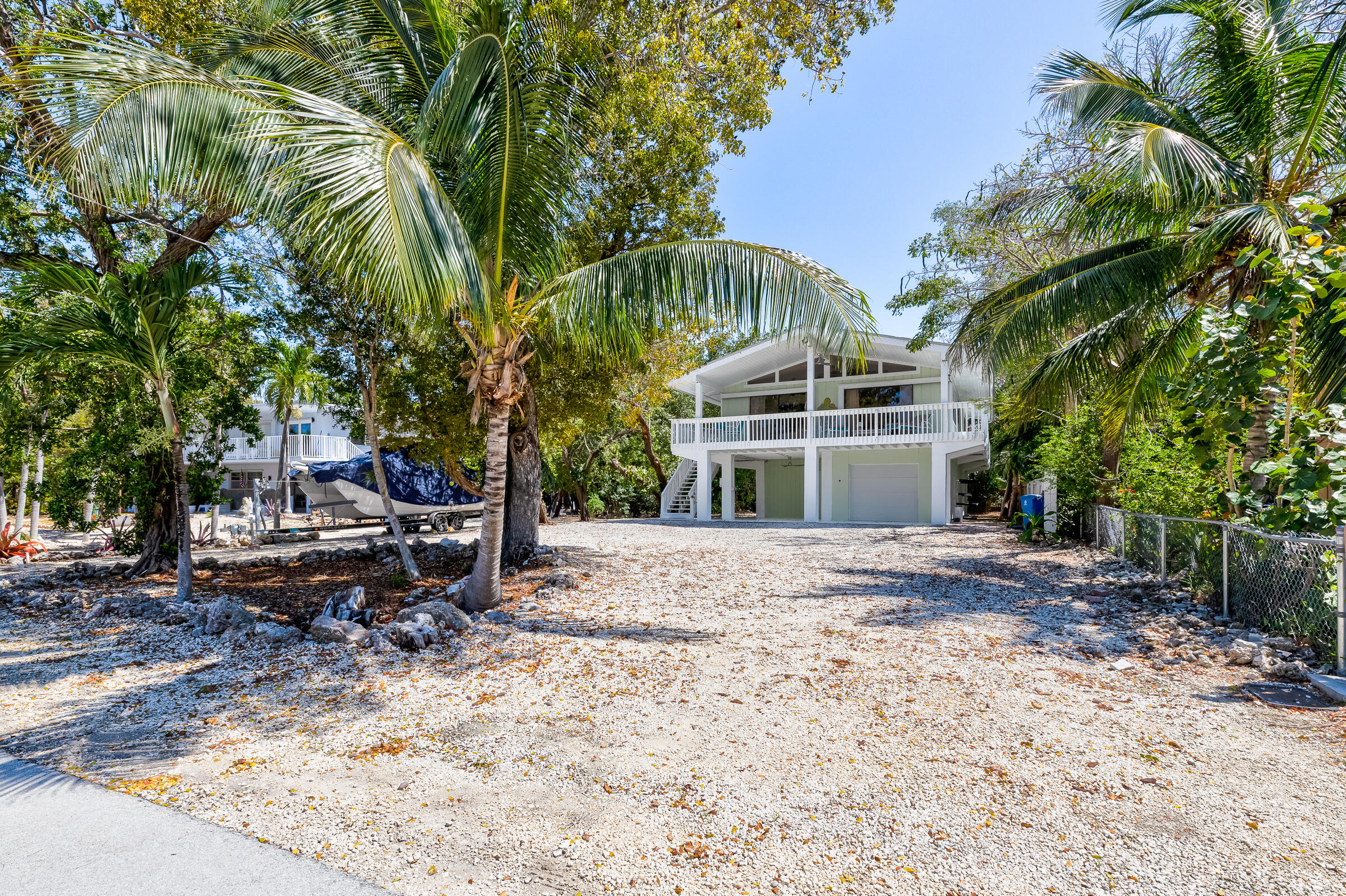 15 Sunset Road Key Largo, FL 33037 - Photo 36 of 58 a front view of a house with a yard and shrubs