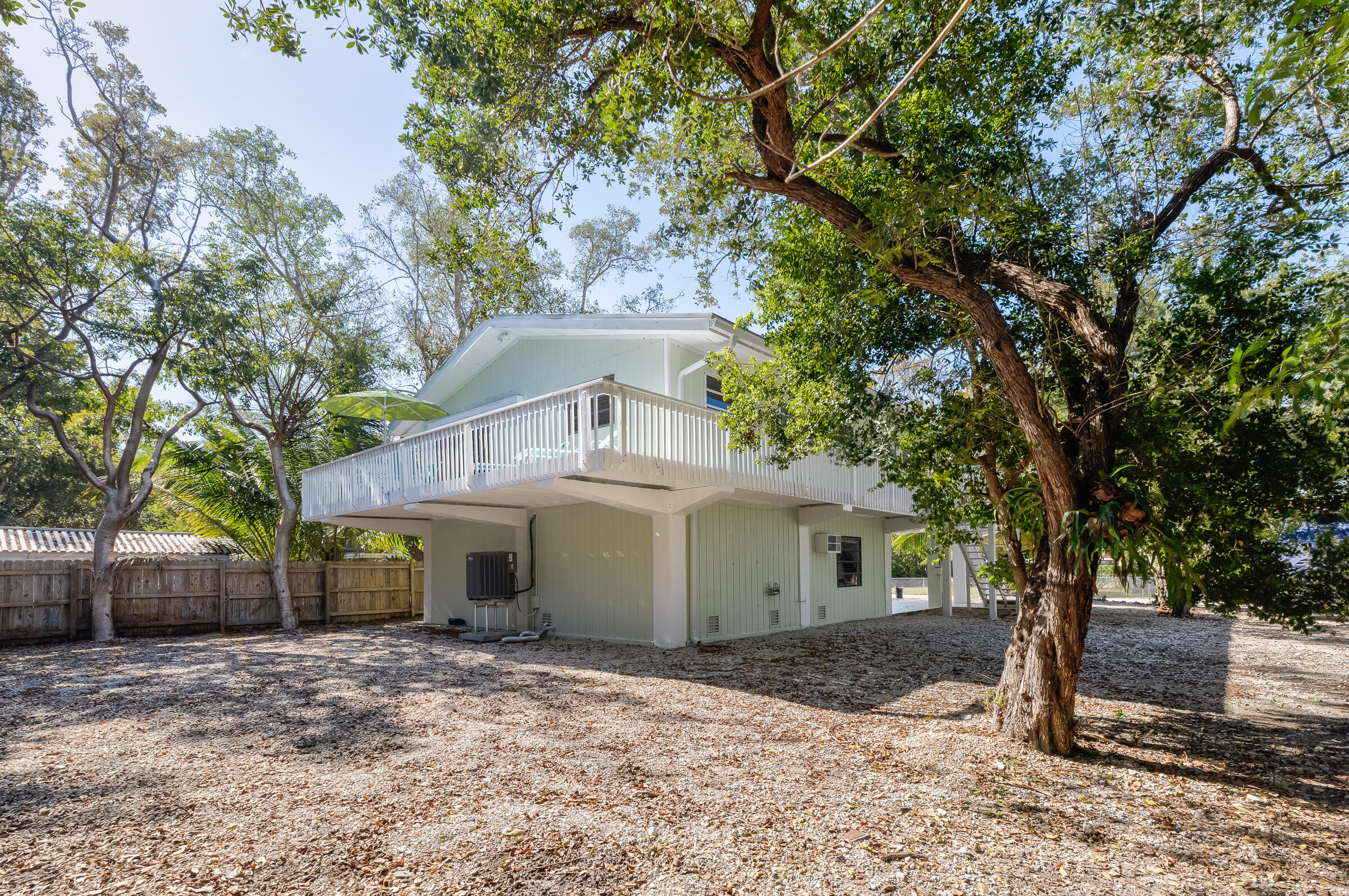 15 Sunset Road Key Largo, FL 33037 - Photo 40 of 58 a view of a house with a yard and large tree