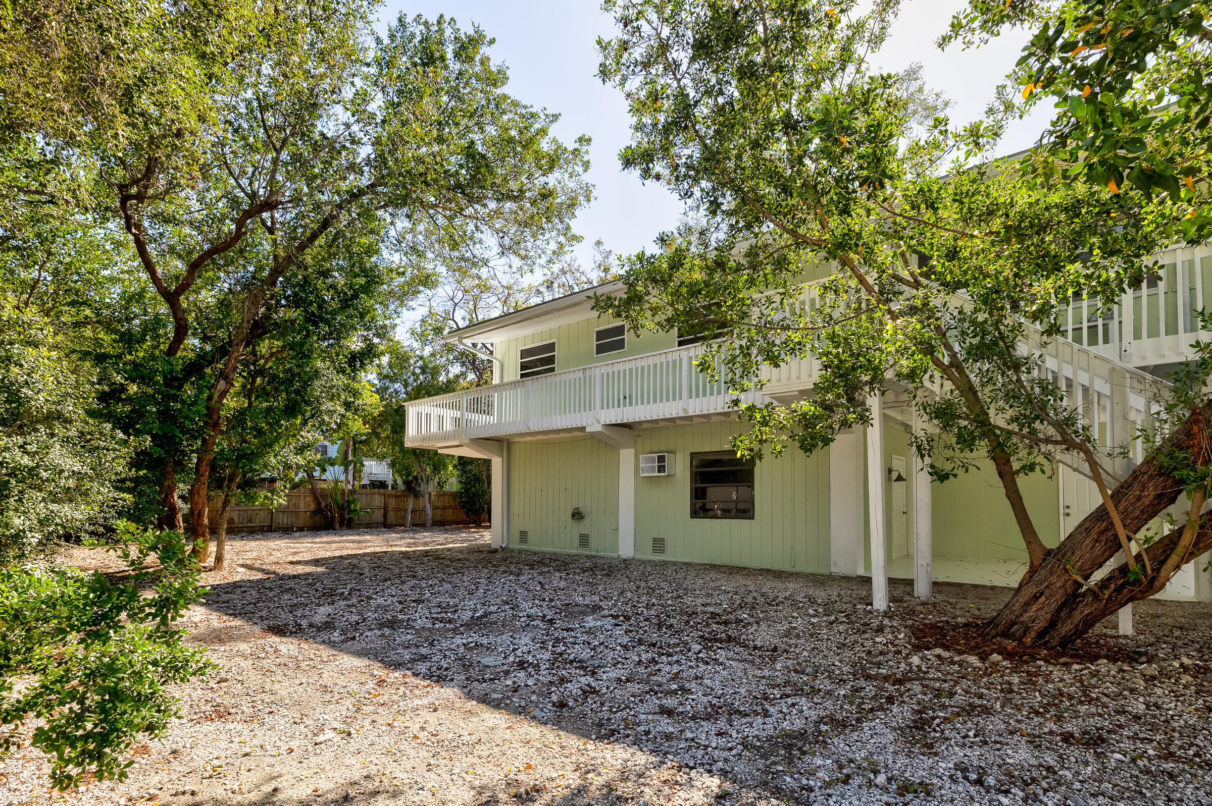 15 Sunset Road Key Largo, FL 33037 - Photo 48 of 58 a view of a house with a yard