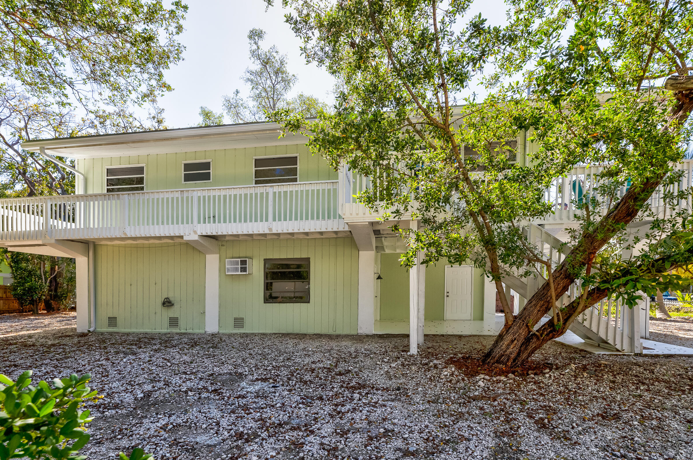 15 Sunset Road Key Largo, FL 33037 - Photo 49 of 58 a view of a house with a yard