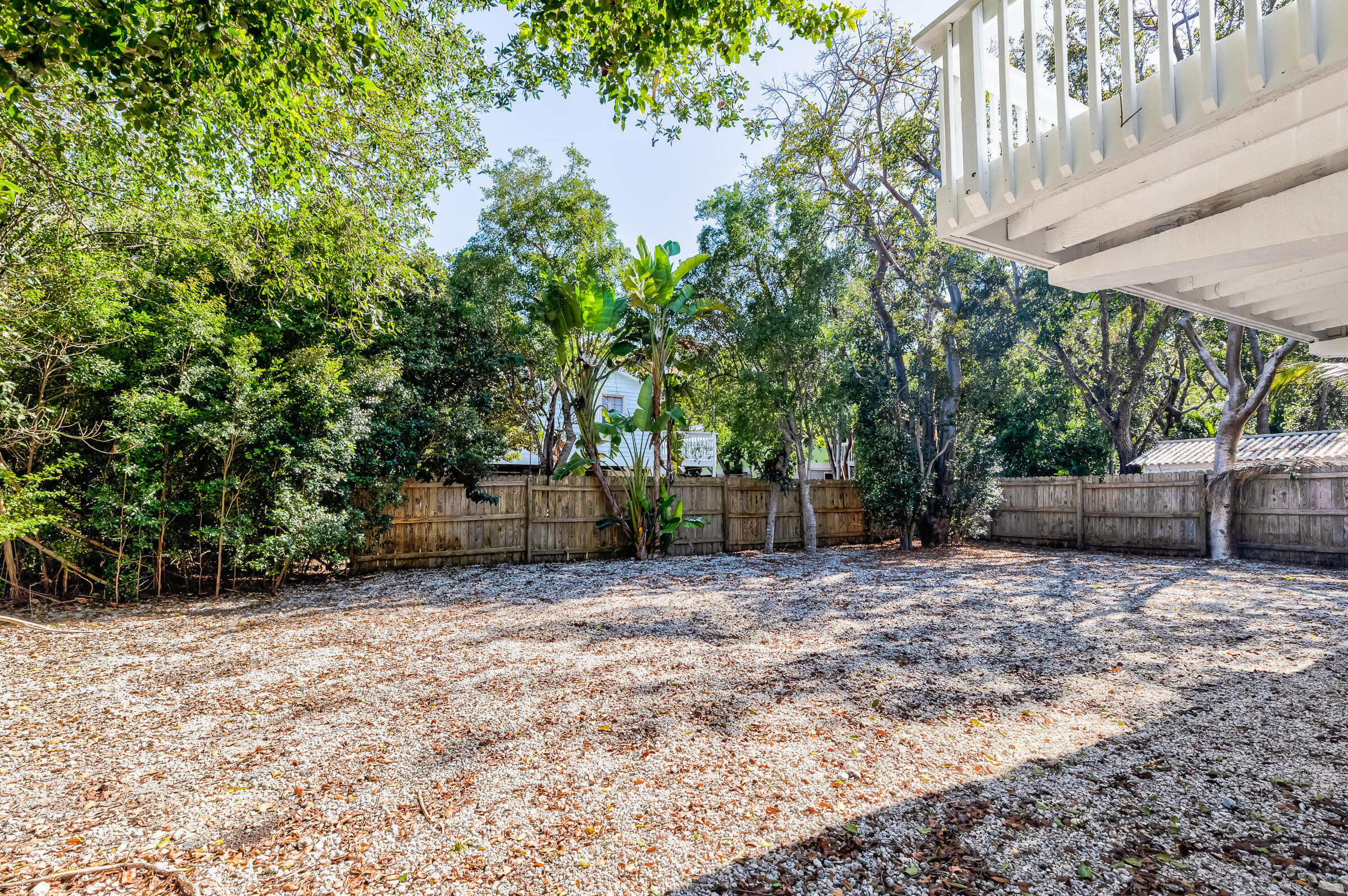 15 Sunset Road Key Largo, FL 33037 - Photo 50 of 58 a backyard of a house with oven table and chairs