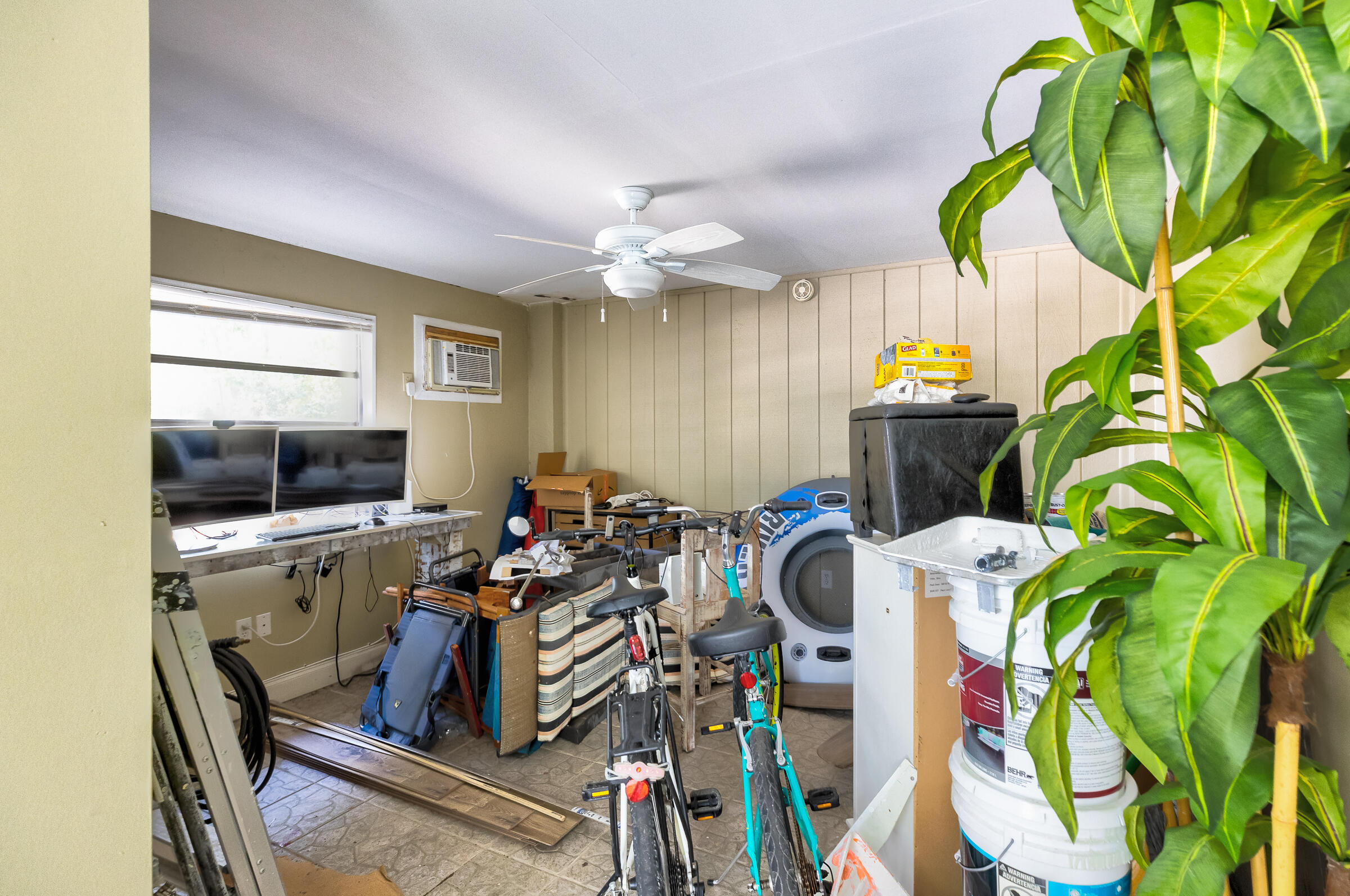15 Sunset Road Key Largo, FL 33037 - Photo 56 of 58 a view of a dining room with furniture a flat screen tv and a chandelier