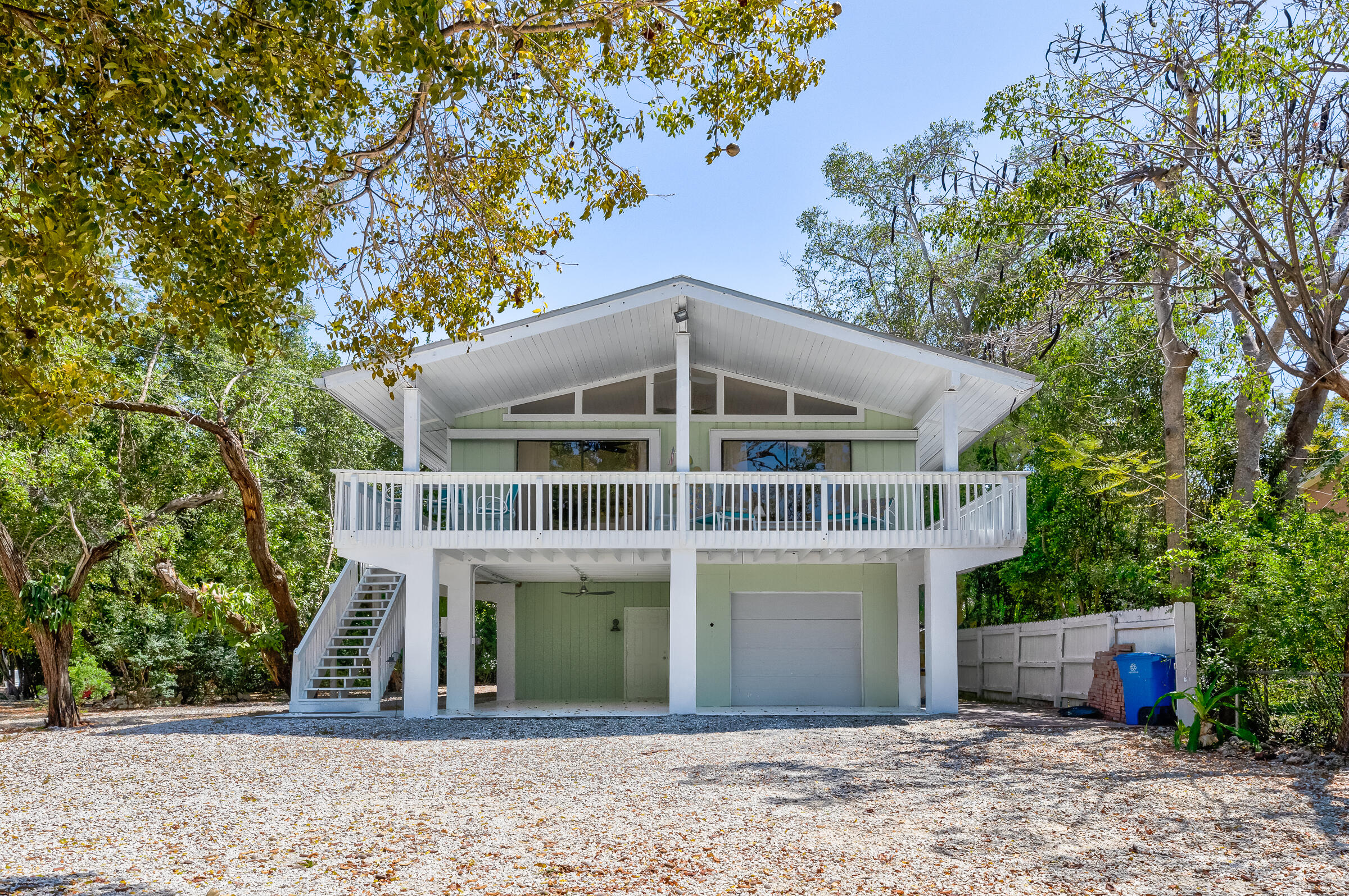 15 Sunset Road Key Largo, FL 33037 - Photo 8 of 58 a front view of a house with a garden