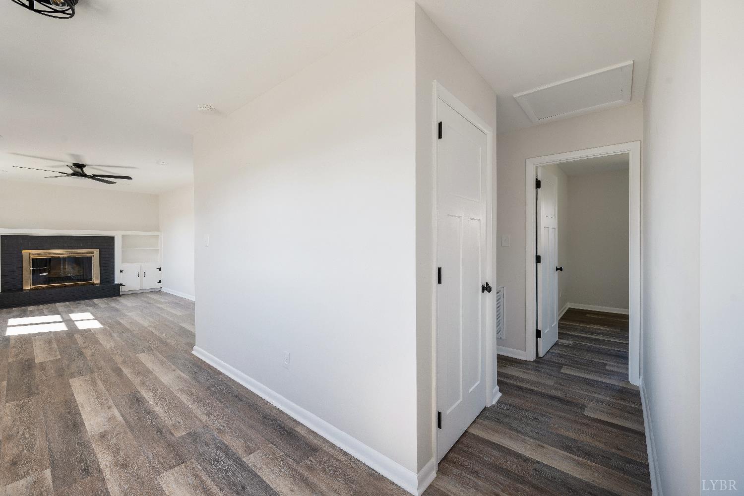 333 North Main Street Amherst, VA 24521 - Photo 14 of 56 a view of a hallway with wooden floor and a fireplace
