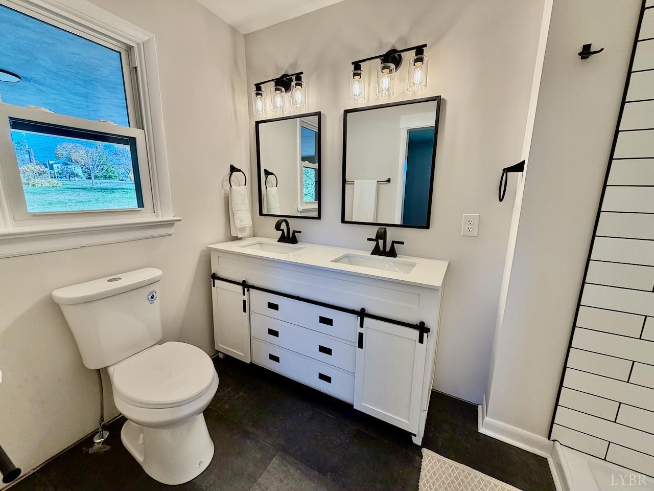 333 North Main Street Amherst, VA 24521 - Photo 17 of 56 a bathroom with a toilet a sink and a mirror