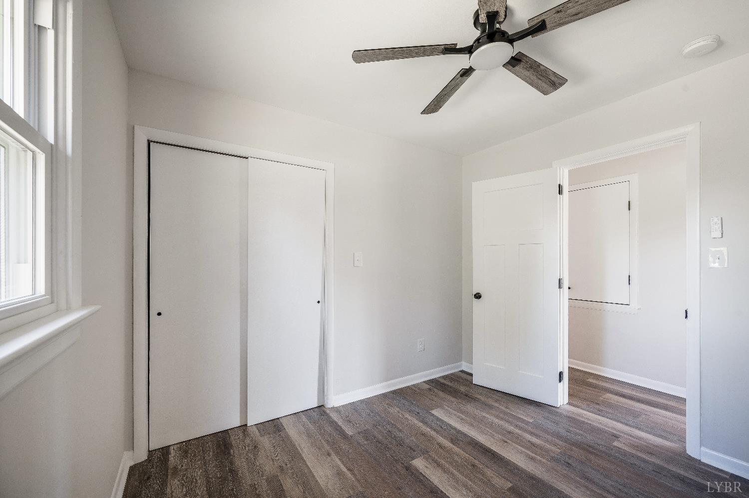 333 North Main Street Amherst, VA 24521 - Photo 23 of 56 an empty room with wooden floor closet and windows