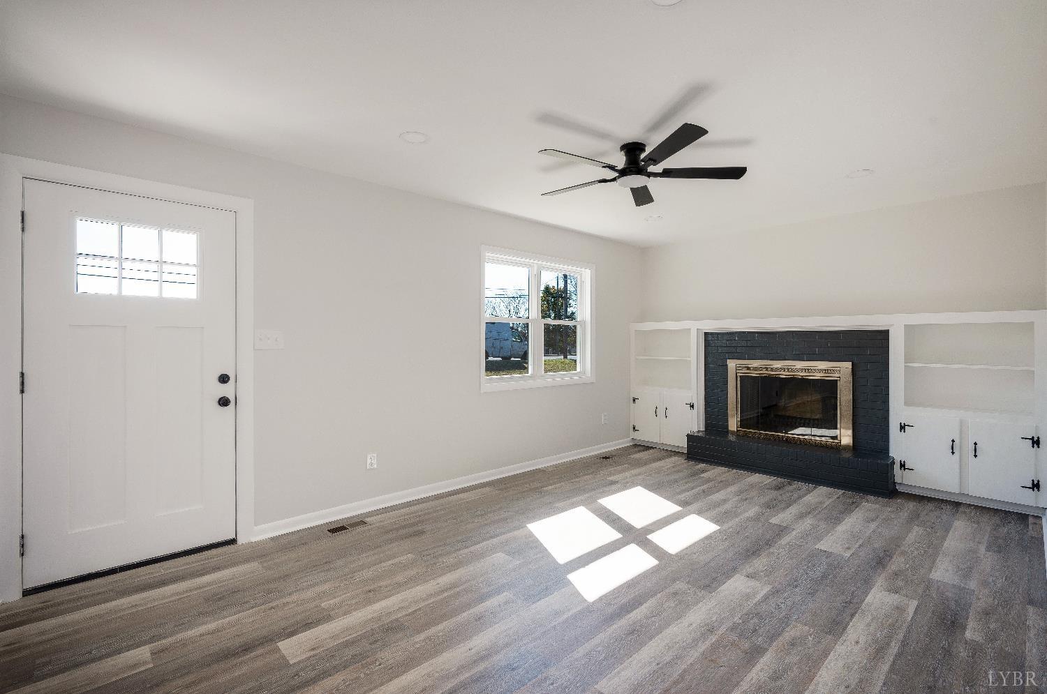 333 North Main Street Amherst, VA 24521 - Photo 4 of 56 an empty room with windows fireplace and windows