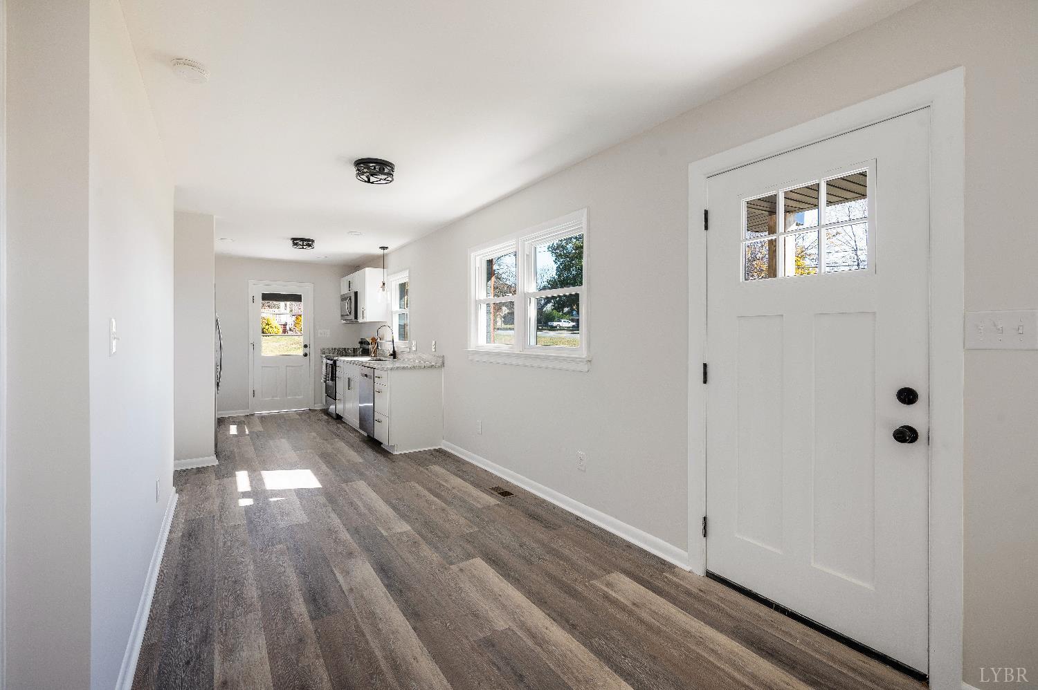 333 North Main Street Amherst, VA 24521 - Photo 6 of 56 a view of a hallway with wooden floor and a living room