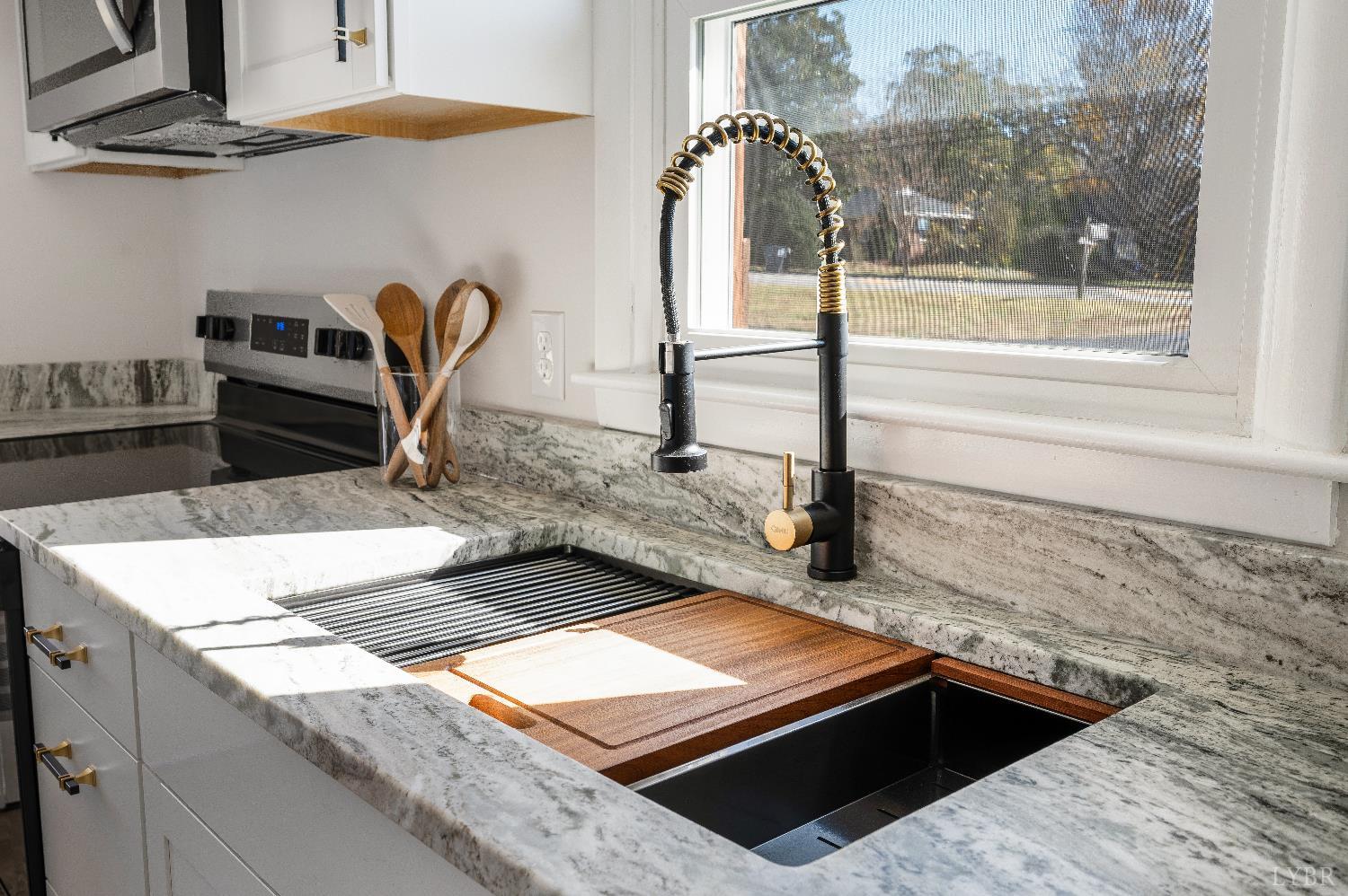 333 North Main Street Amherst, VA 24521 - Photo 9 of 56 a kitchen with kitchen island granite countertop a sink and a stove