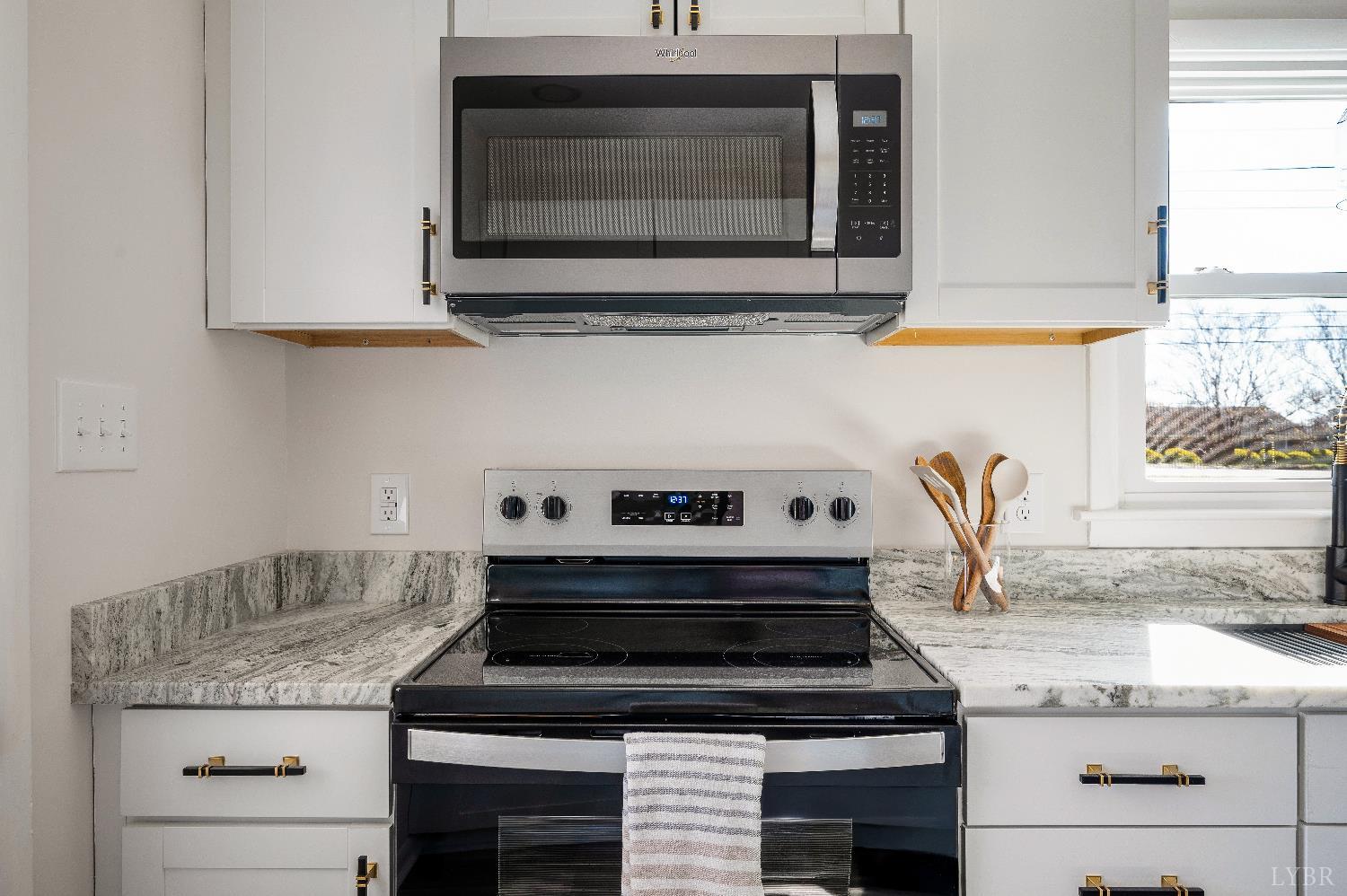 333 North Main Street Amherst, VA 24521 - Photo 10 of 56 a kitchen with granite countertop a stove and a sink