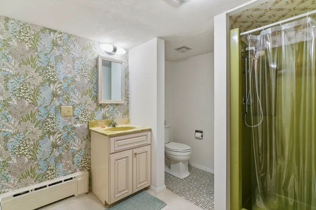 a view of a utility room with a sink and a mirror
