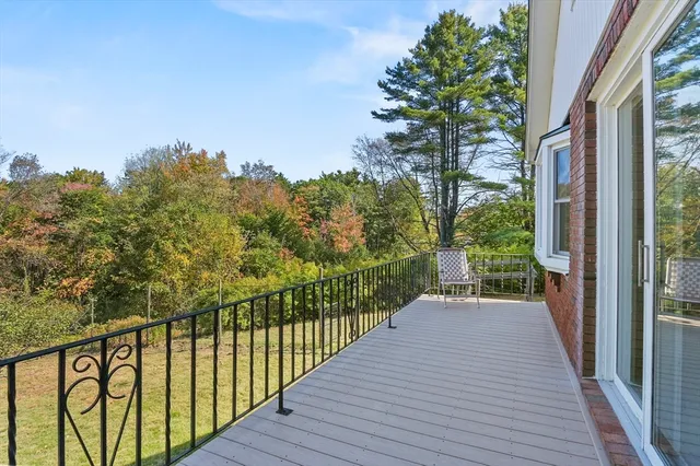 a view of a house with a backyard and a tree
