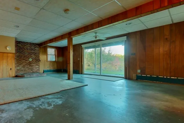 a view of empty room with wooden floor and windows