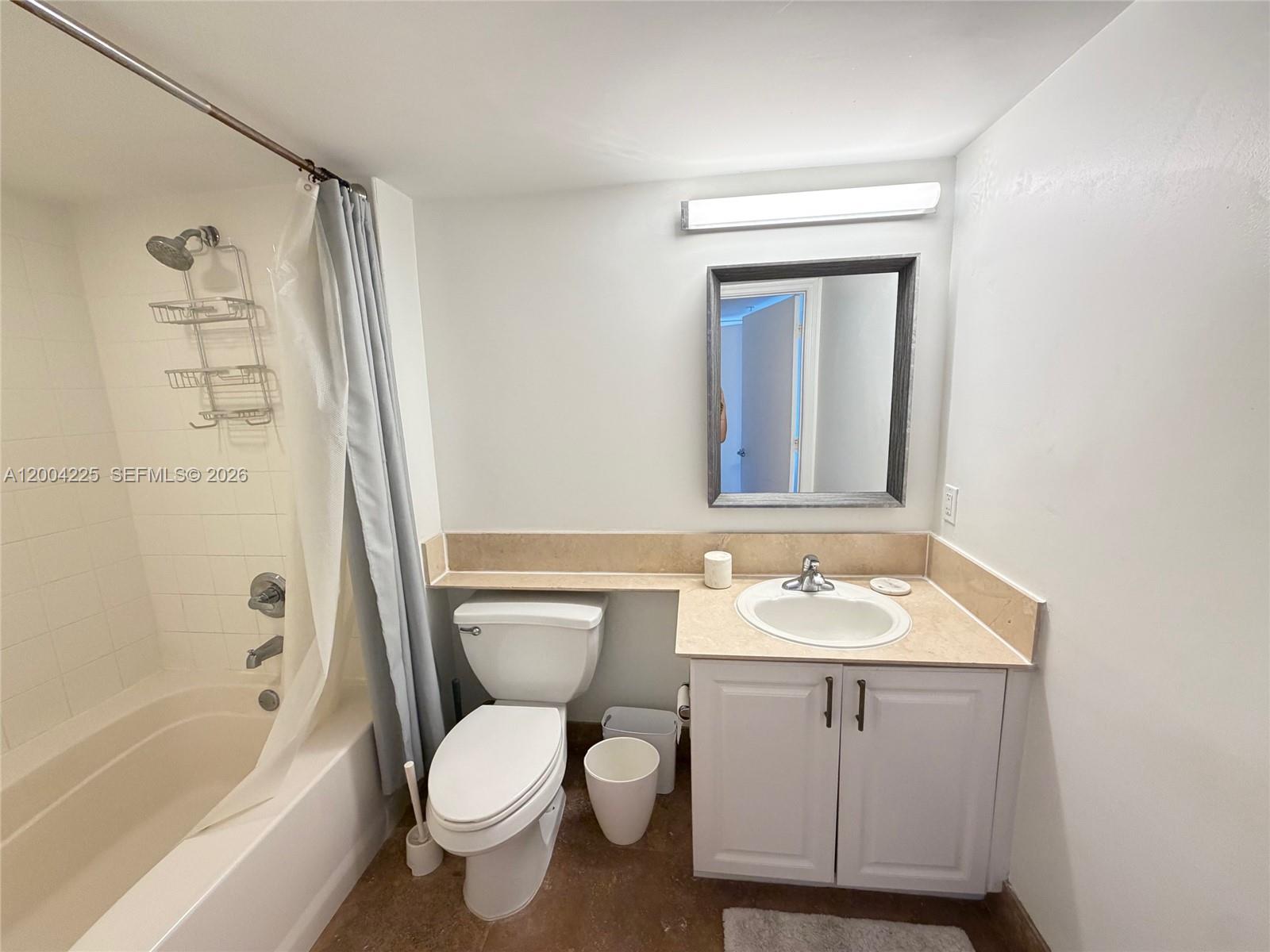 90 Alton Road, Unit 301 Miami Beach, FL 33139 - Photo 8 of 18 a bathroom with a sink toilet and shower