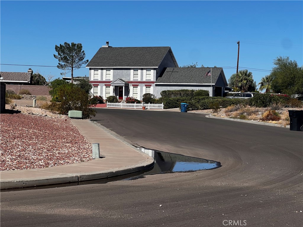 0 2031 Carty Place Needles, CA 92363 - Photo 6 of 12 a front view of a house with yard and parking
