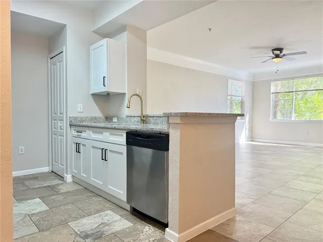 a kitchen with stainless steel appliances granite countertop a sink and a stove