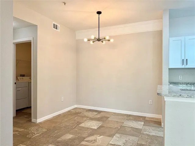 a view of a kitchen with a sink and cabinets