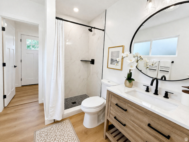 266 700 West Provo, UT 84601 - Photo 12 of 18 Bathroom featuring a stall shower, light wood-type flooring, and vanity