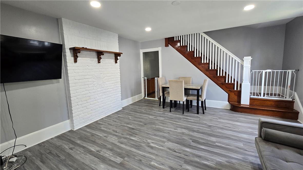 883 North Locust Street Hazleton, PA 18201 - Photo 14 of 83 A versatile living space with wood flooring and a classic wooden staircase.