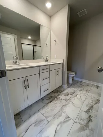 a spacious bathroom with a sink and mirror