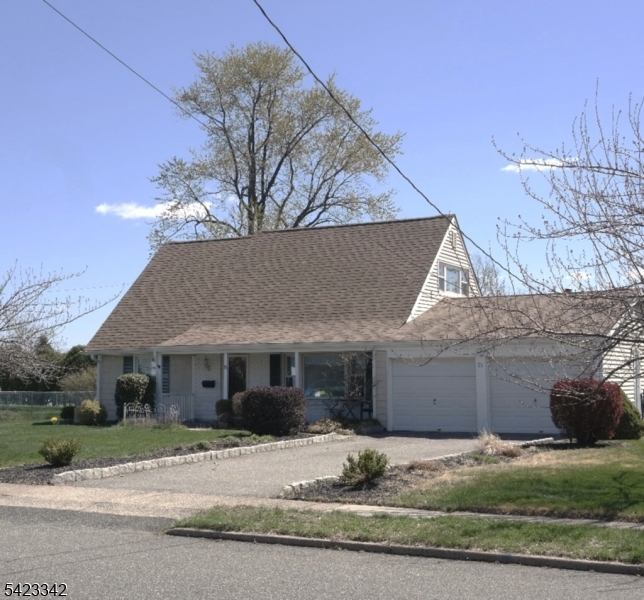a view of a house with a patio and a yard