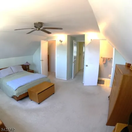 a spacious bedroom with a bed and cabinets