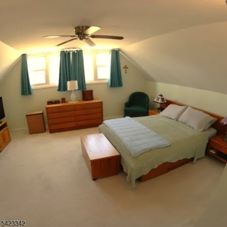 a bedroom with bed and a chandelier