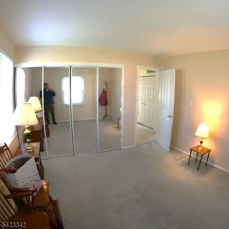 a view of living room filled with furniture and a window
