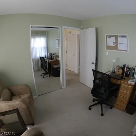 a living room with furniture and a piano