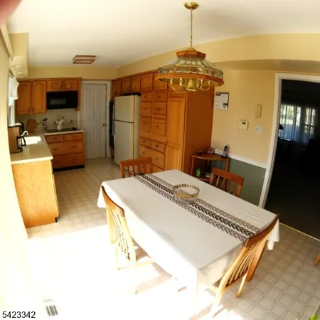 a spacious bedroom with a bed a dresser and a flat screen tv