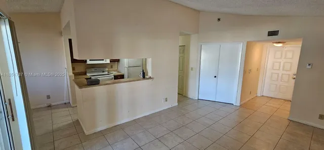 a view of a chandelier fan and entryway