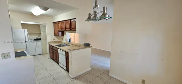 a kitchen with granite countertop a stove and a refrigerator