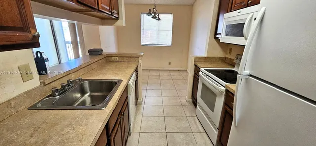 a kitchen with a sink a stove and cabinets