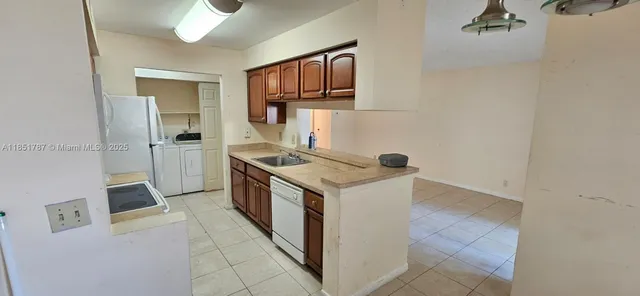 a view of a livingroom with wooden floor and a carpet