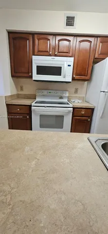 a kitchen with stainless steel appliances a refrigerator stove and microwave