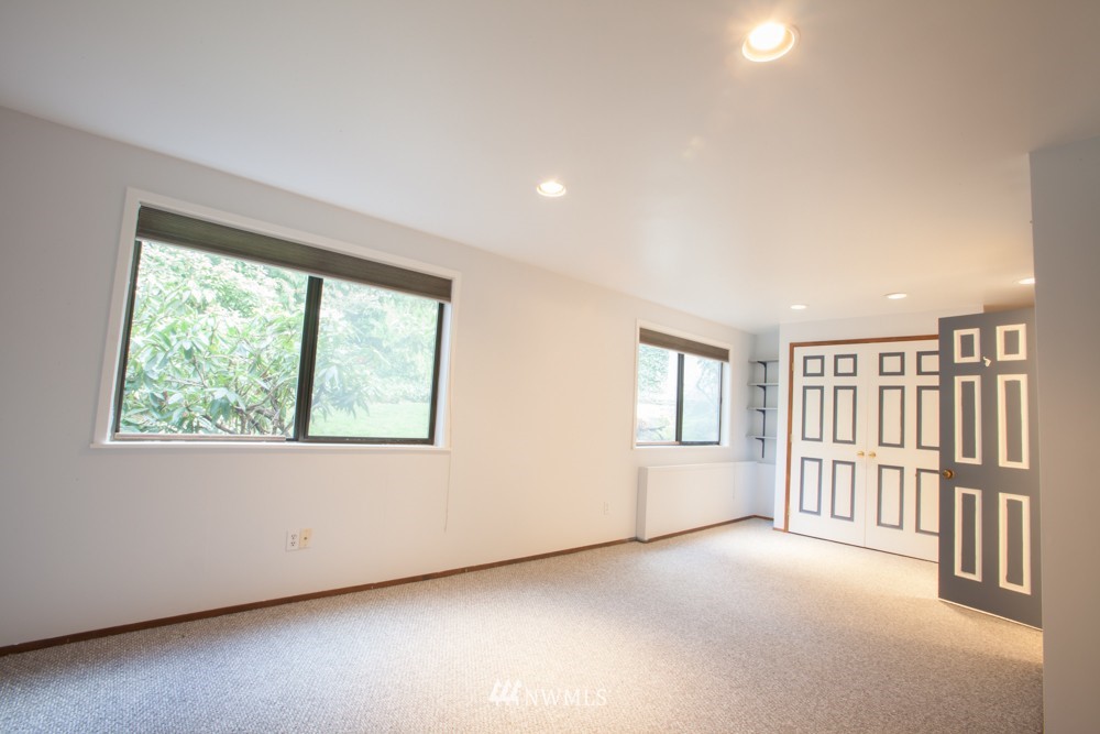 5558 West Mercer Way Mercer Island, WA 98040 - Photo 15 of 20 an empty room with a fireplace and windows