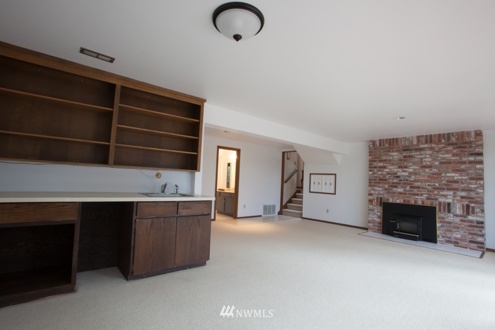 5558 West Mercer Way Mercer Island, WA 98040 - Photo 16 of 20 a kitchen with cabinets and fireplace